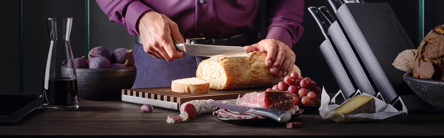 Classic ikon chef cutting a loaf of bread