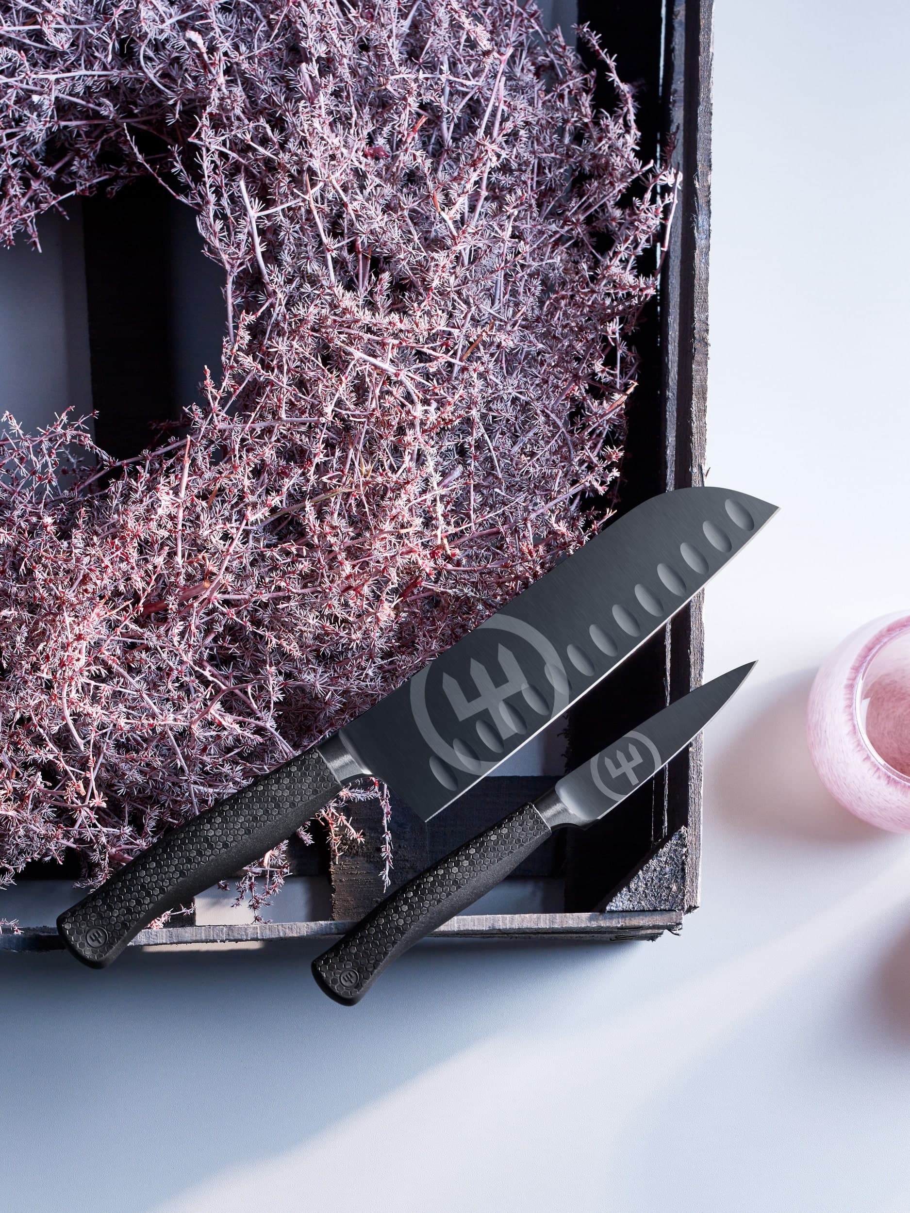 Performer knife next to purple wreath and glass cups