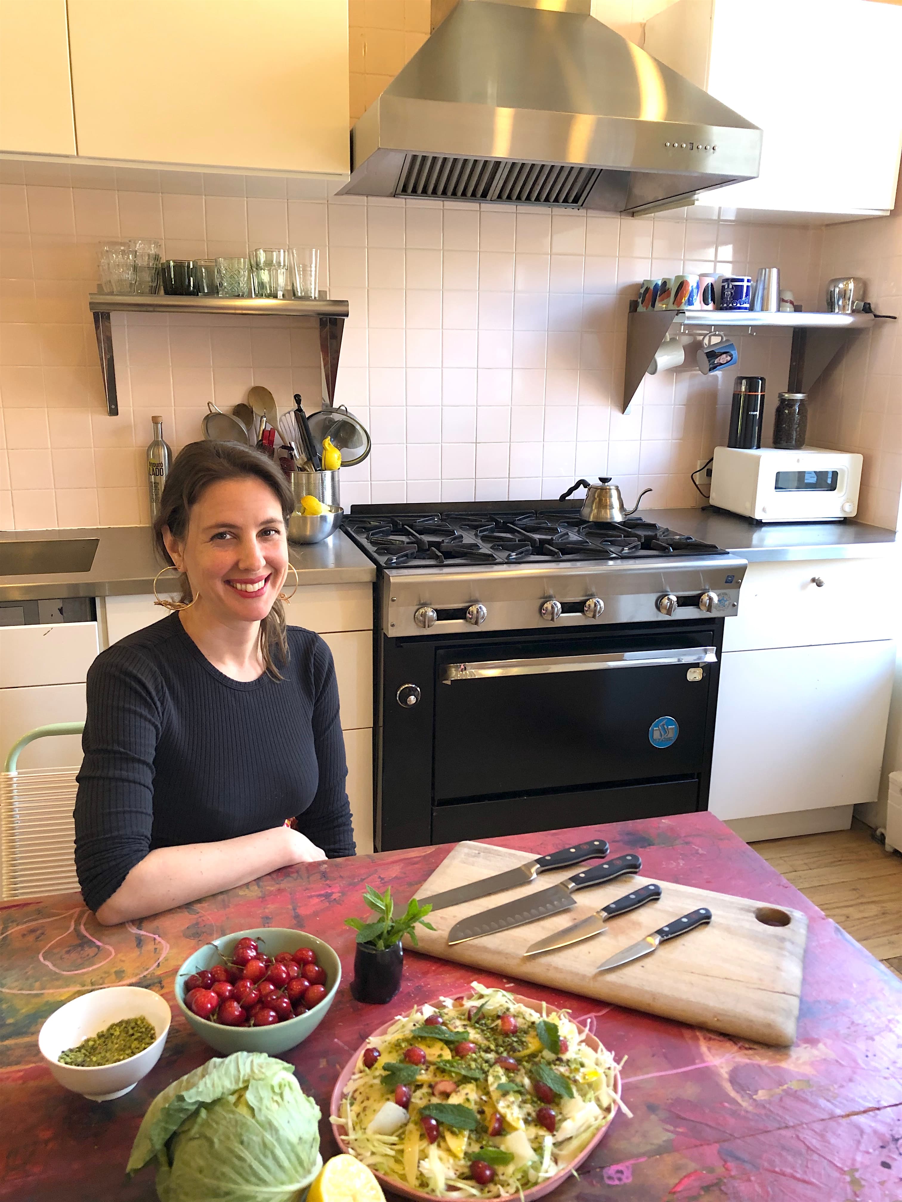 Chef Mina Stone sitting in her kitchen with her WÜSTHOF knives.