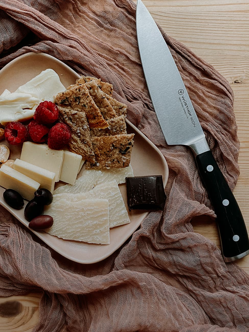 Ikon Chef's Knife on table with charcuterie board