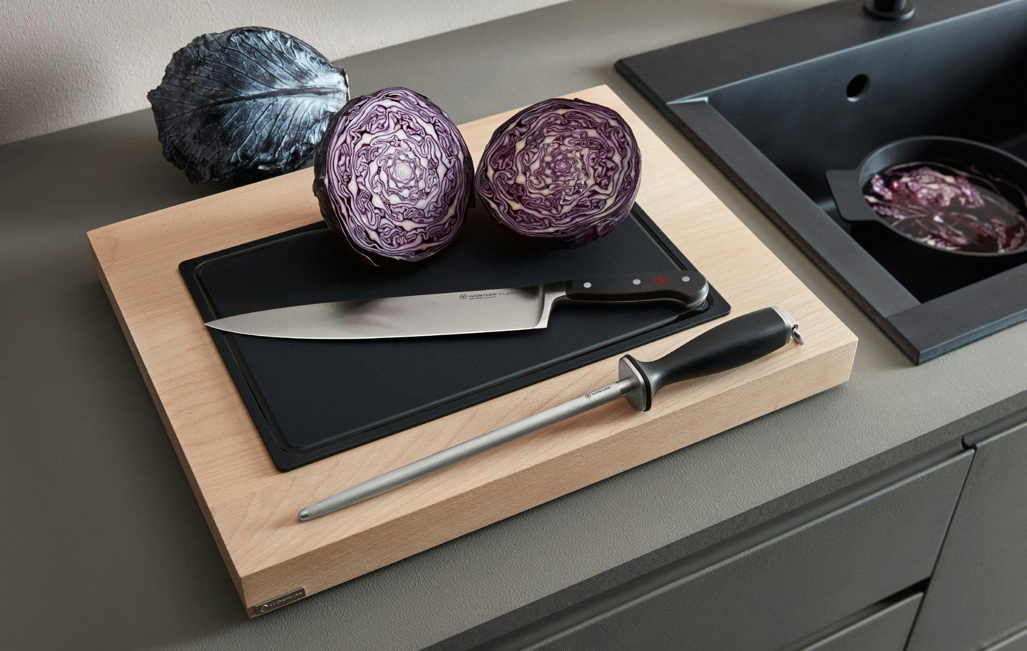 Wusthof Knife and sharpening honing steel next to a freshly-cut red cabbage